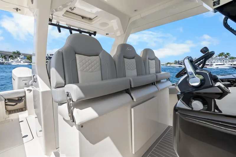 Slide: The Image of 2024 Scout 425 LXF boat interior with luxurious seating and modern steering console. - 36
