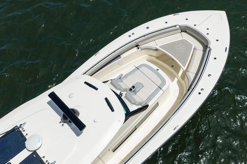 Slide: The Image of 2024 Scout 425 LXF boat, aerial view, showcasing sleek design and spacious deck. - 14