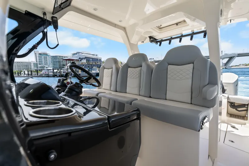 Slide: The Image of 2024 Scout 425 LXF boat interior with luxurious seating and modern dashboard. - 37