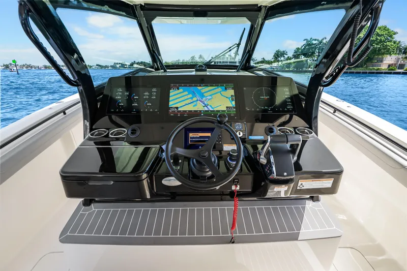 Slide: The Image of 2024 Scout 425 LXF boat dashboard with advanced navigation system on a sunny day. - 33