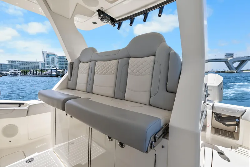 Slide: The Image of Luxurious seating on the 2024 Scout 425 LXF boat, with waterfront cityscape in the background. - 38