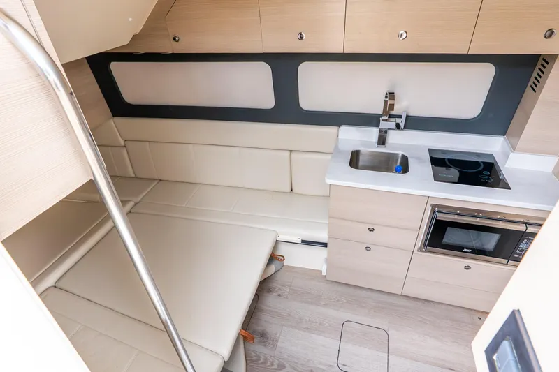 Slide: The Image of Luxurious interior of 2024 Scout 425 LXF boat with kitchenette and seating area. - 46