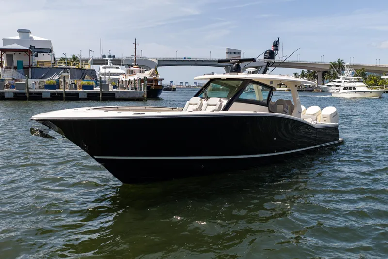 Slide: The Image of 2024 Scout 425 LXF luxury boat docked in a marina, showcasing sleek design. - 15