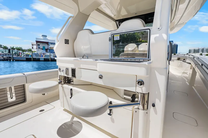 Slide: The Image of 2024 Scout 425 LXF luxury boat interior with seating and sleek design at marina. - 41