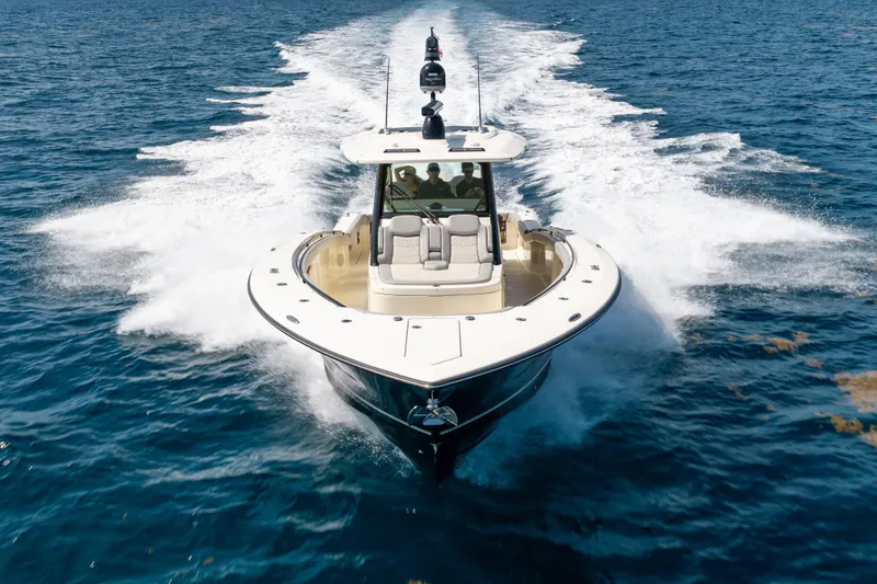 Slide: The Image of 2024 Scout 425 LXF boat cruising on open blue water. - 5