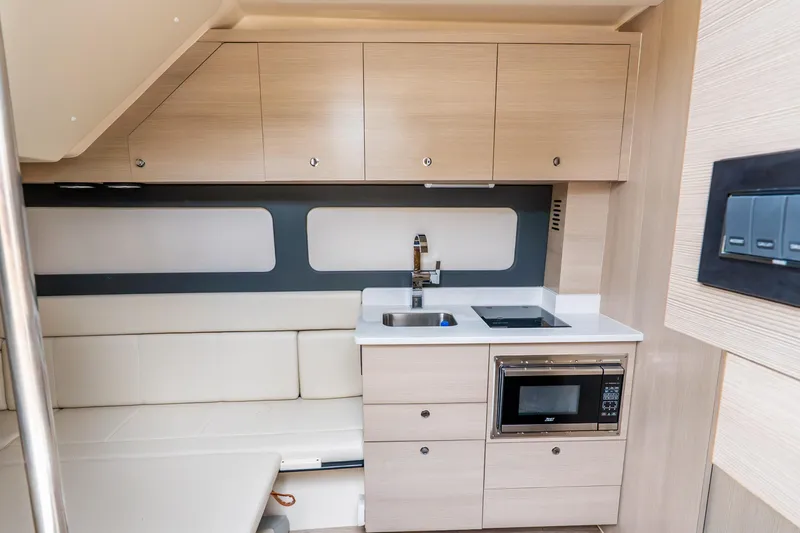 Slide: The Image of 2024 Scout 425 LXF yacht interior kitchen with modern cabinetry and appliances. - 48