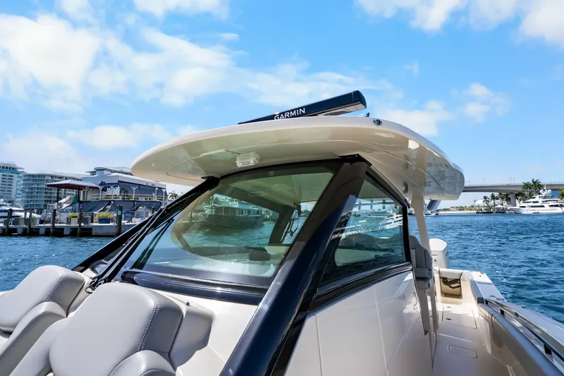 Slide: The Image of 2024 Scout 425 LXF boat docked, showcasing sleek design and advanced navigation equipment. - 30