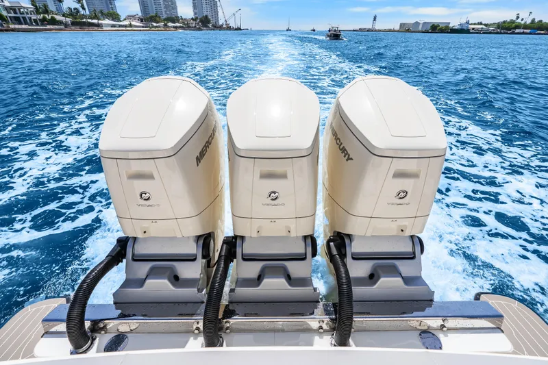 Slide: The Image of Triple Mercury outboard engines on a 2024 Scout 425 LXF cruising through blue waters. - 22