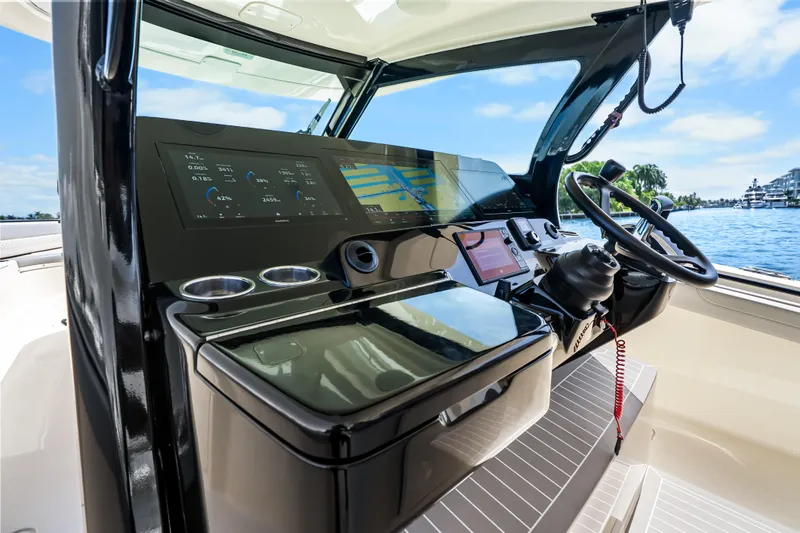 Slide: The Image of 2024 Scout 425 LXF boat cockpit with advanced navigation and control systems. - 34