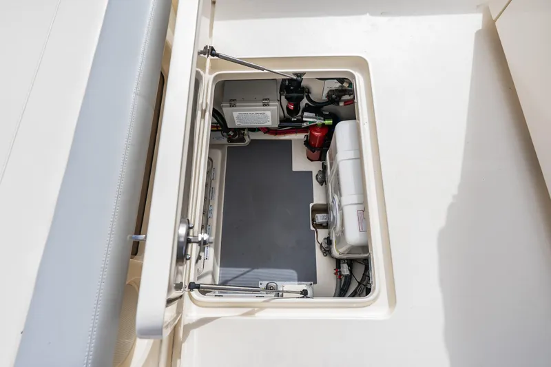 Slide: The Image of 2024 Scout 425 LXF boat storage compartment with mechanical components and wiring. - 18
