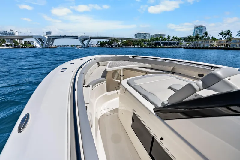 Slide: The Image of 2024 Scout 425 LXF luxury boat cruising near a bridge on a sunny day. - 26