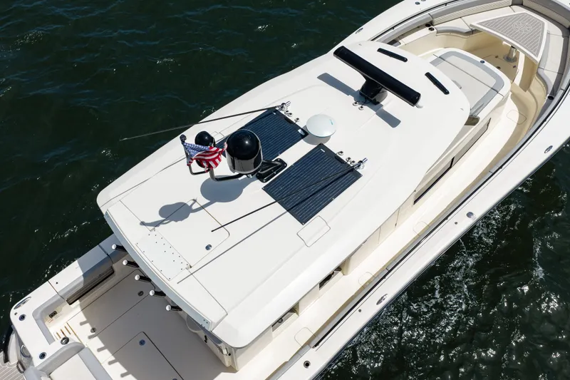 Slide: The Image of 2024 Scout 425 LXF boat on water, aerial view showcasing deck and solar panels. - 12