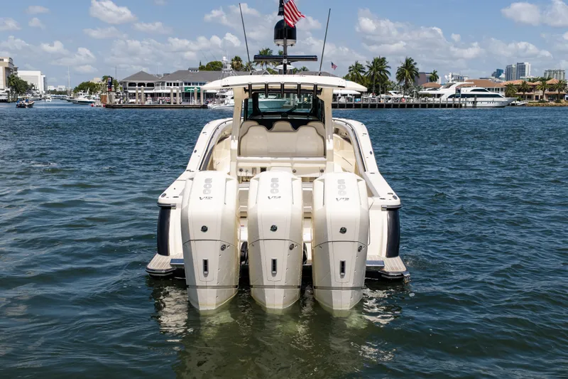 Slide: The Image of 2024 Scout 425 LXF boat with four powerful outboard engines on the water. - 6