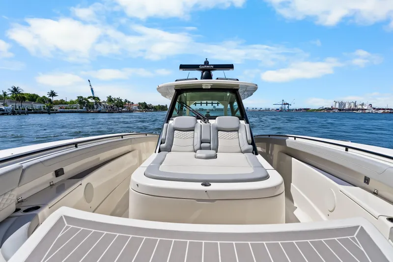 Slide: The Image of 2024 Scout 425 LXF luxury boat on water, showcasing sleek design and spacious seating. - 28
