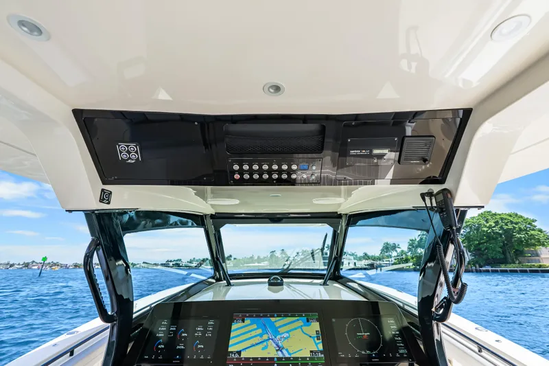 Slide: The Image of 2024 Scout 425 LXF boat dashboard with advanced navigation system on a sunny day. - 35