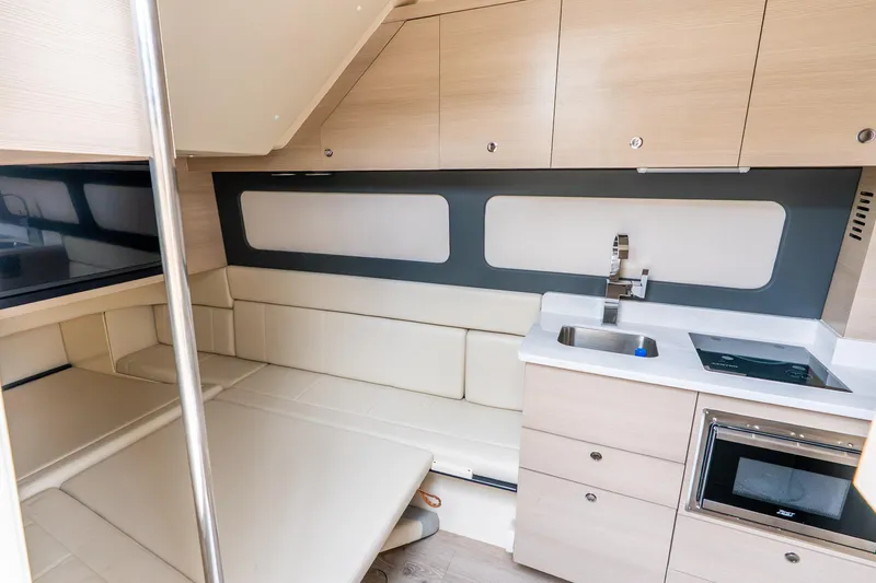 Slide: The Image of Luxurious interior of 2024 Scout 425 LXF yacht featuring modern kitchenette and seating area. - 47