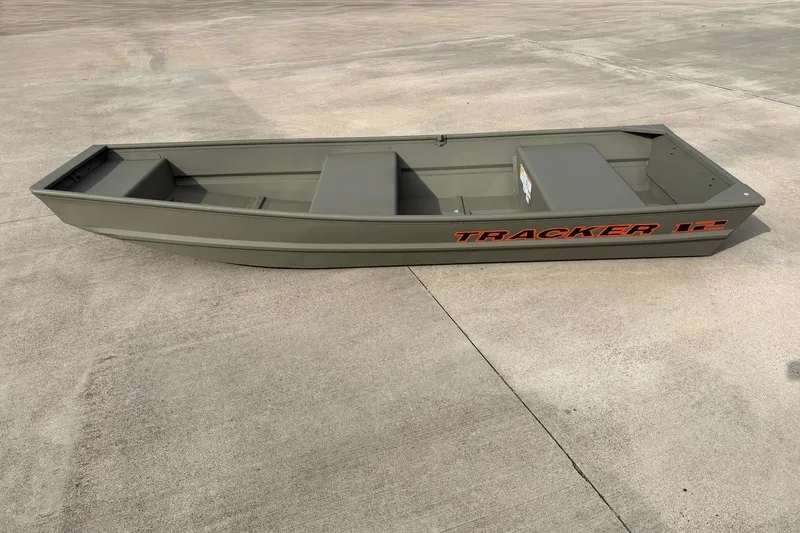 The Image of 2026 Tracker Grizzly 12 Jon boat on concrete surface, showcasing its sleek design. - 0