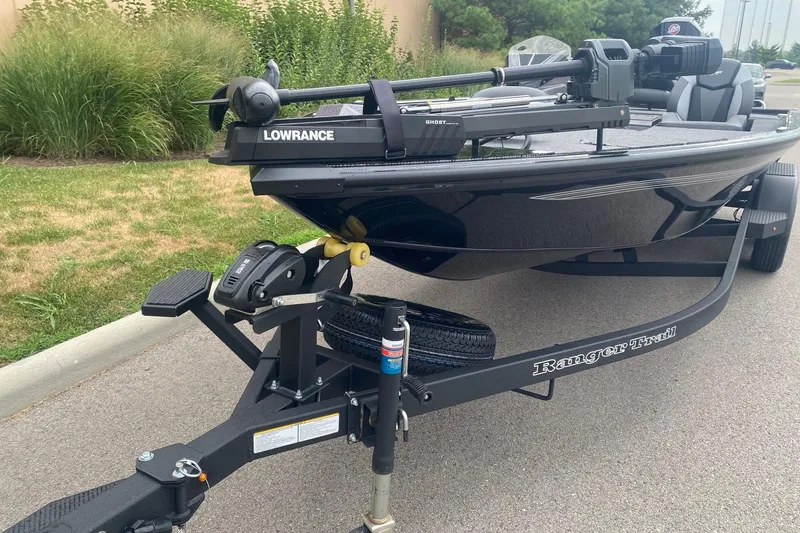 Slide: The Image of 2026 Ranger ALPHA 208 boat on trailer with Lowrance equipment, parked on a road. - 1