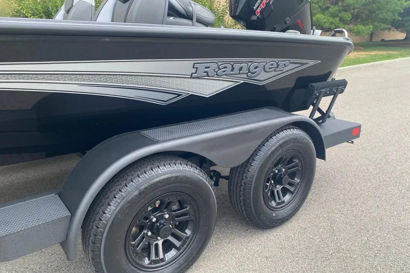 Slide: The Image of Ranger ALPHA 208 boat trailer with dual wheels, 2026 model, parked on pavement. - 3