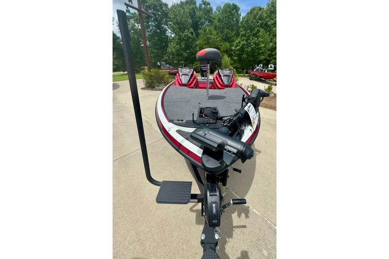 Slide: The Image of 2026 Nitro Z19 XL Pro boat with red accents, parked on a driveway. - 2