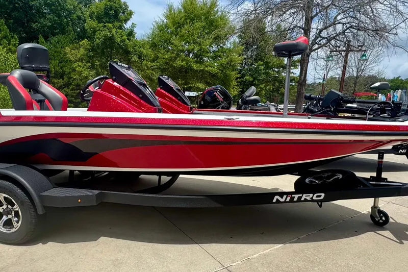 The Image of 2026 Nitro Z19 XL Pro boat in vibrant red on a trailer, parked outdoors. - 0