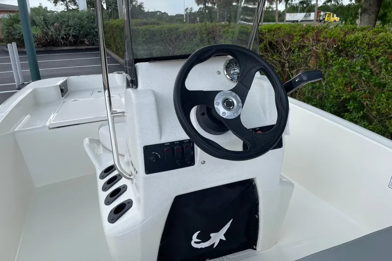 Slide: The Image of 2026 Mako Pro Skiff 15 CC boat console with steering wheel and controls. - 8