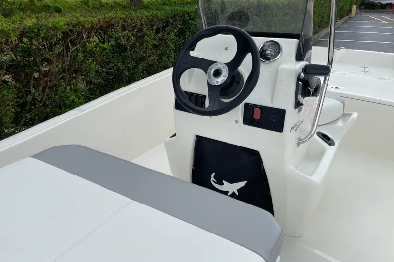 Slide: The Image of 2026 Mako Pro Skiff 15 CC boat interior with steering wheel and console. - 7