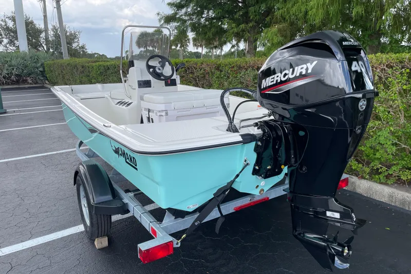 Slide: The Image of 2026 Mako Pro Skiff 15 CC boat with Mercury engine on trailer. - 5