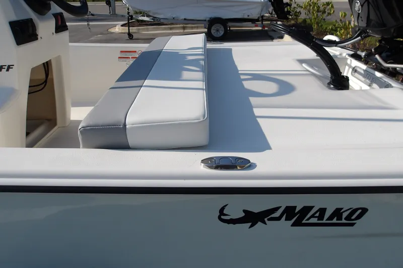 Slide: The Image of 2026 Mako Pro Skiff 13 CC boat interior with cushioned seating and logo. - 14