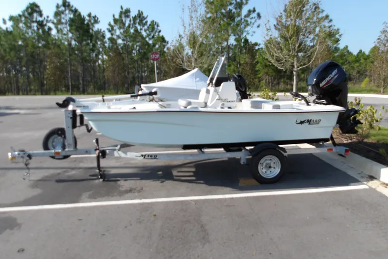 The Image of 2026 Mako Pro Skiff 13 CC boat on trailer in parking lot. - 1