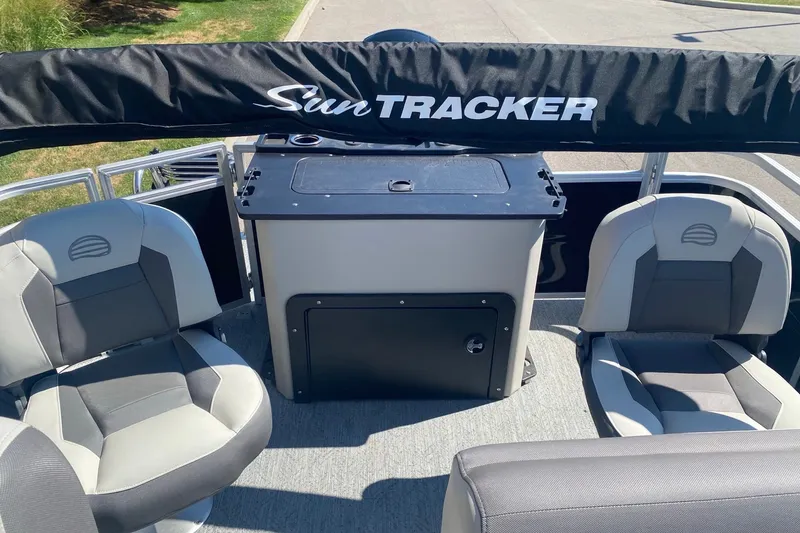 Slide: The Image of 2026 Sun Tracker Fishin' Barge 22 DLX interior with seating and console. - 7