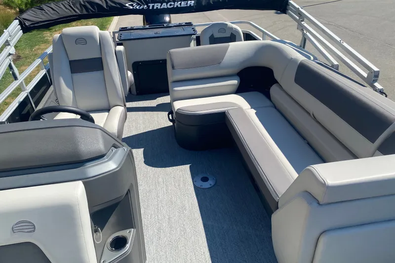 Slide: The Image of 2026 Sun Tracker Fishin' Barge 22 DLX interior with plush seating and modern design. - 8