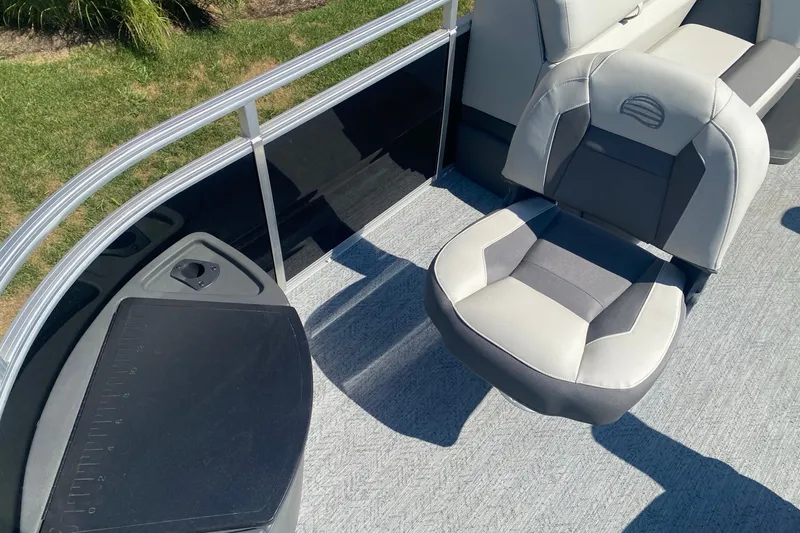 Slide: The Image of 2026 Sun Tracker Fishin' Barge 22 DLX interior with comfortable seating and sleek design. - 4