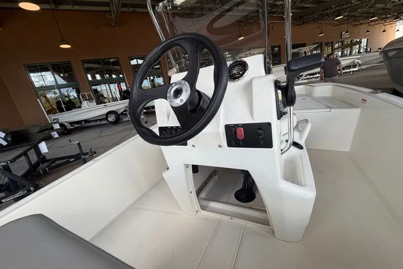 Slide: The Image of 2026 Mako Pro Skiff 15 CC boat console with steering wheel and controls. - 3