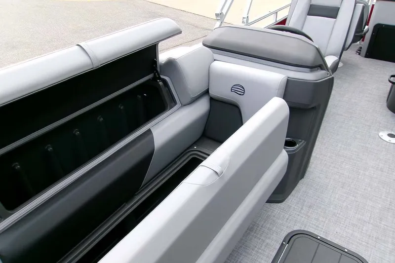 Slide: The Image of 2026 Sun Tracker Sportfish 24 XP3 interior with open storage compartments and seating. - 13