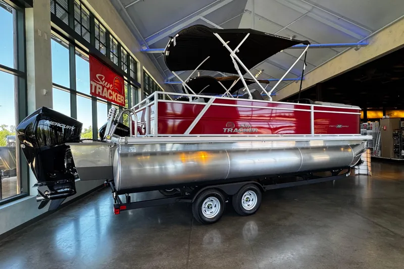 Slide: The Image of 2026 Sun Tracker Party Barge 22 RF XP3 pontoon boat displayed indoors. - 2