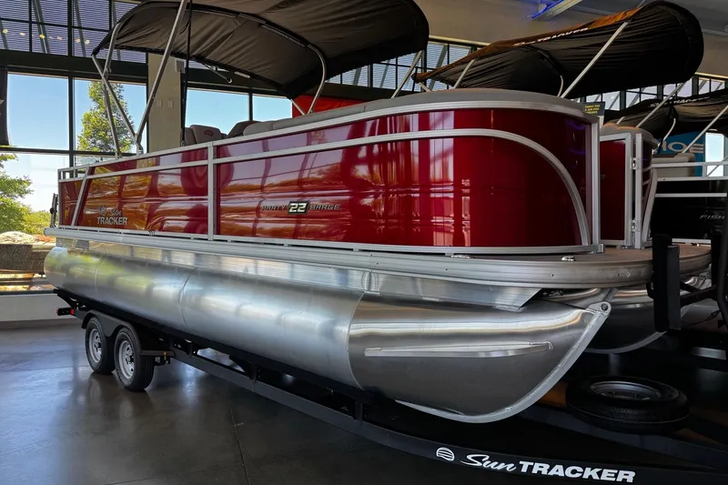 Slide: The Image of 2026 Sun Tracker Party Barge 22 RF XP3 pontoon boat displayed indoors. - 1