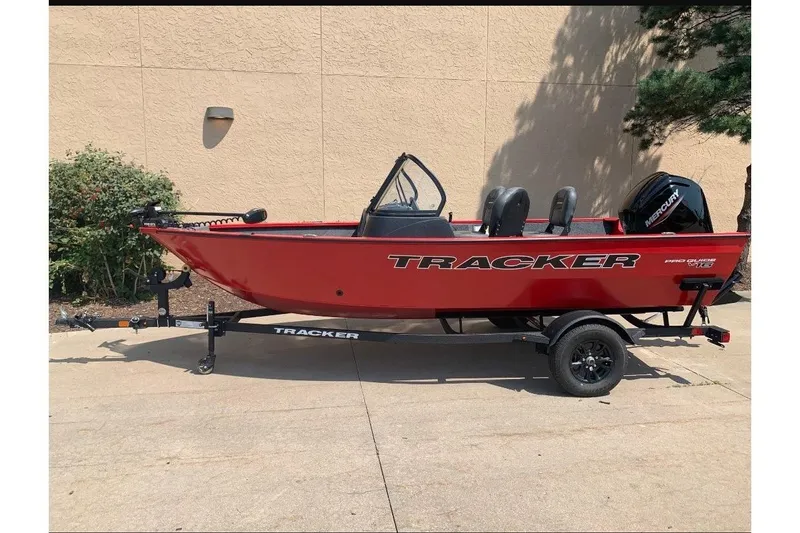 The Image of 2026 Tracker Pro Guide V-16 WT boat in vibrant red, parked outdoors. - 0
