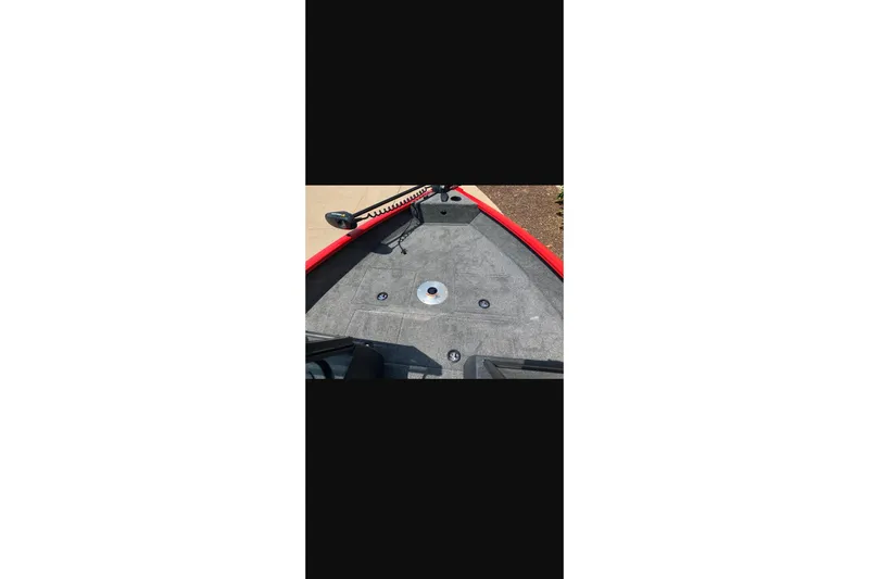 Slide: The Image of 2026 Tracker Pro Guide V-16 WT boat interior with gray flooring and red trim. - 11