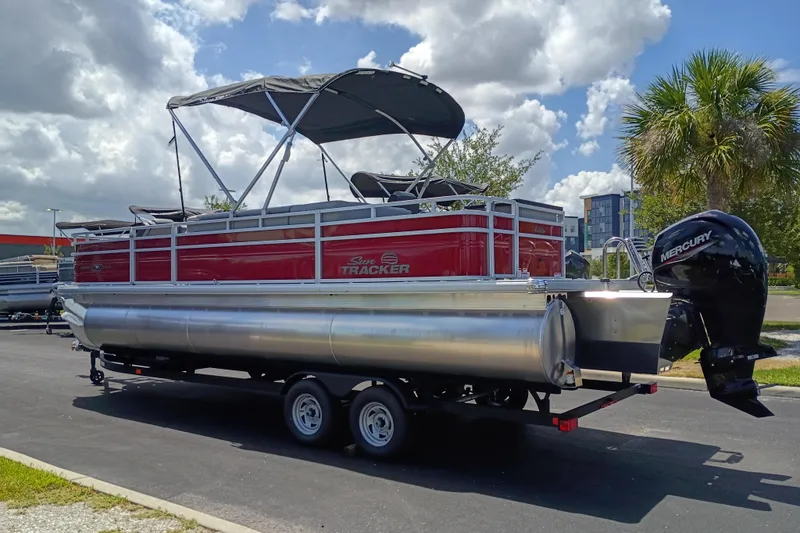 Slide: The Image of 2026 Sun Tracker Sportfish 24 XP3 pontoon boat with Mercury engine on trailer. - 2