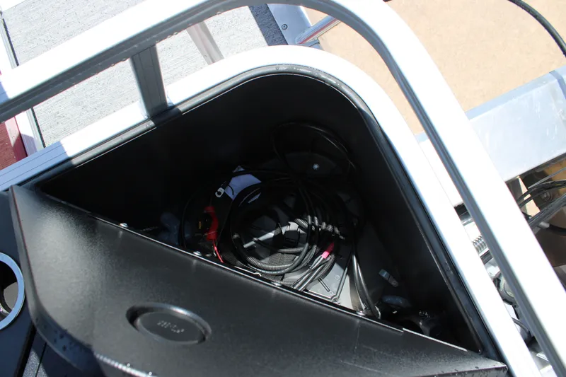 Slide: The Image of Storage compartment of 2026 Sun Tracker Bass Buggy 18 DLX with cables and equipment. - 15
