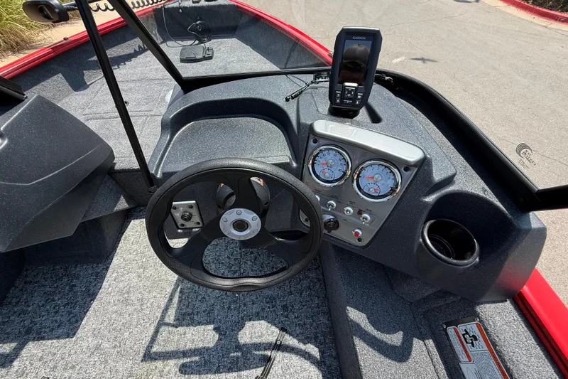 Slide: The Image of 2026 Tracker Pro Guide V-16 WT boat dashboard with steering wheel and gauges. - 20