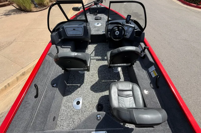 Slide: The Image of Interior of 2026 Tracker Pro Guide V-16 WT boat with seating and steering console. - 14