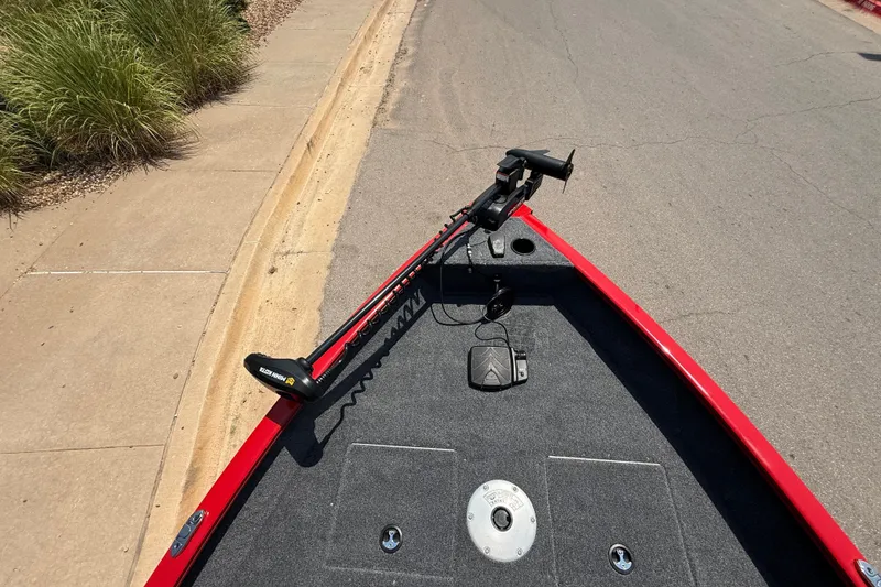 Slide: The Image of 2026 Tracker Pro Guide V-16 WT boat with trolling motor on a paved road. - 21