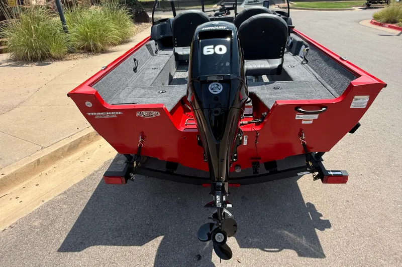 Slide: The Image of 2026 Tracker Pro Guide V-16 WT boat with Mercury 60 engine, parked on pavement. - 17