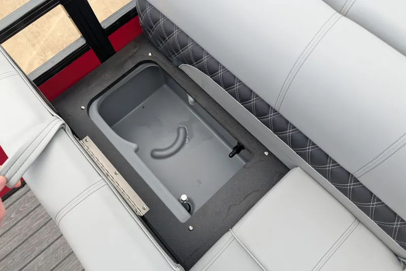 Slide: The Image of 2026 Ranger 220F boat seat storage compartment with gray upholstery and diamond stitching. - 12