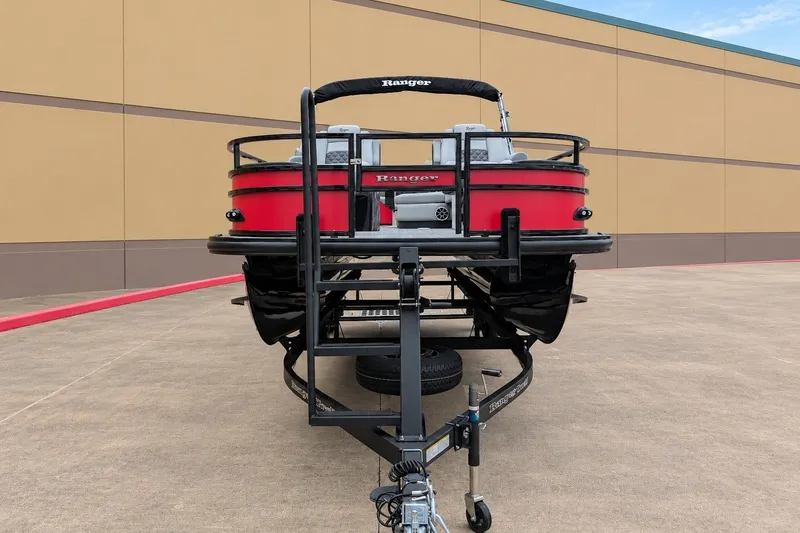 Slide: The Image of 2026 Ranger 220F boat on trailer, red exterior, parked on concrete surface. - 2