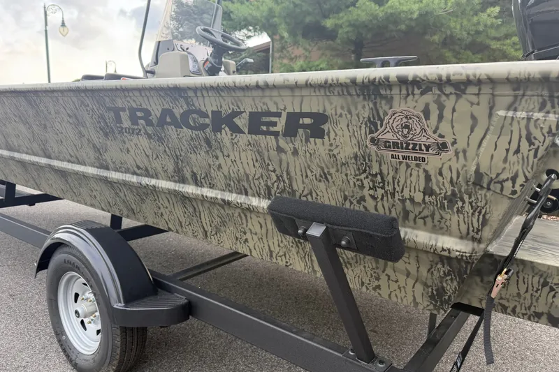 Slide: The Image of 2026 Tracker Grizzly 2072 CC boat with camouflage design on a trailer. - 11