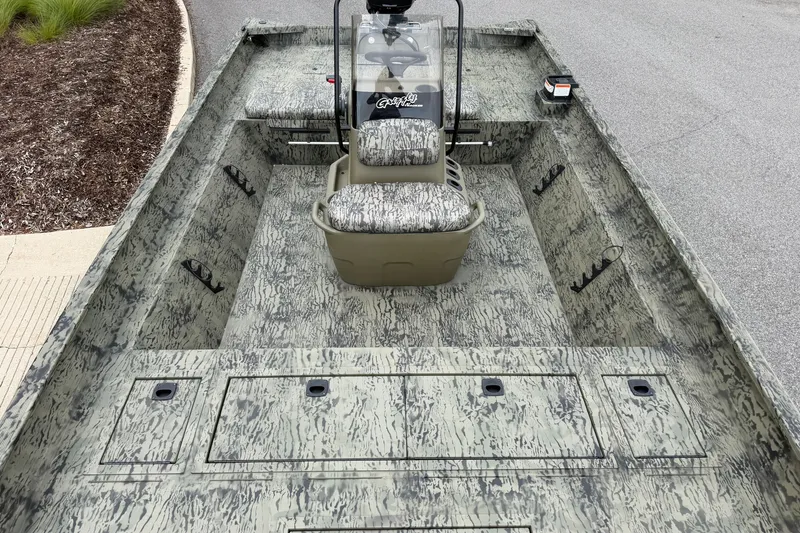 Slide: The Image of 2026 Tracker Grizzly 2072 CC boat with camouflage interior and central console. - 3