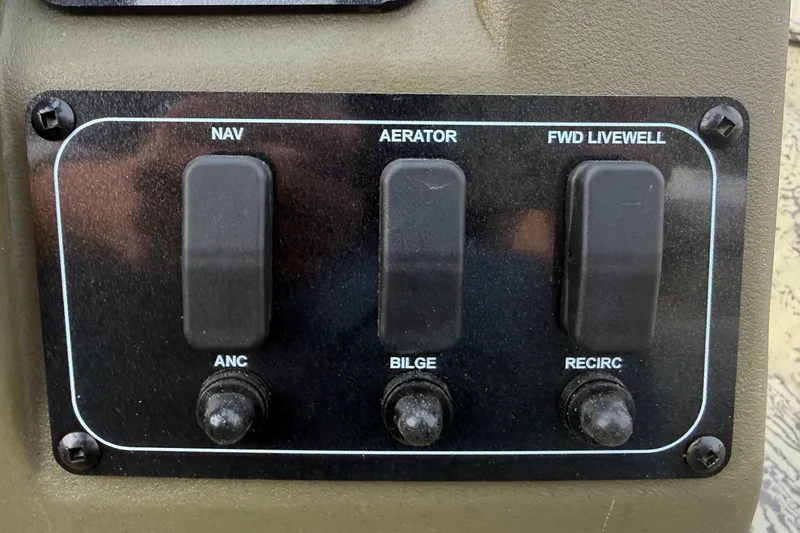 Slide: The Image of Control panel of 2026 Tracker Grizzly 2072 CC boat with switches for navigation and bilge. - 10